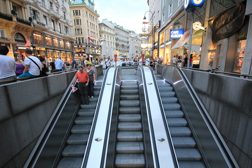 Vienna, Austria-June 21, 2013: Buildings and Escalator at Stephansplatz Square, People Going Down the Escalator, Vienna, Austria.