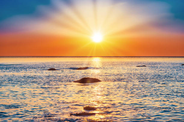 istock Sunset sea and beach with rocks 1287061713