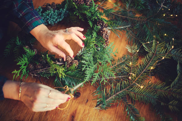 istock Female hands making a Christmas wreath 1287064159