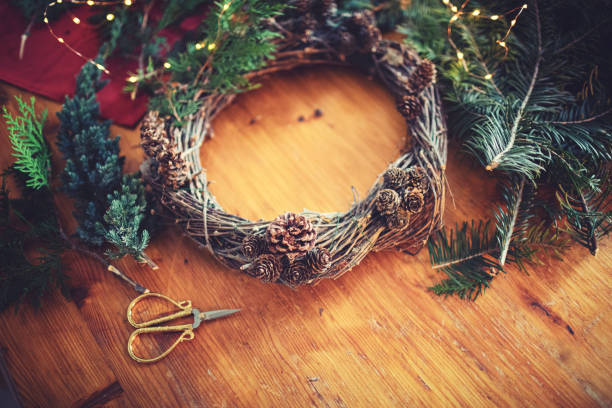 istock Female hands making a Christmas wreath 1287064227