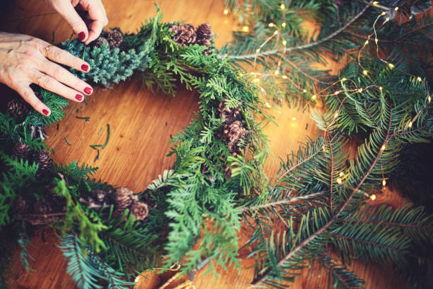 istock Female hands making a Christmas wreath 1287064323