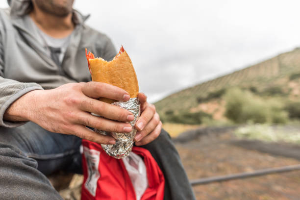 istock man eating sanwich after work collecting olive oil 1287064424