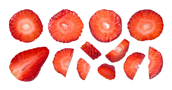 Slices of fresh ripe strawberries isolated on white background. Large set of chopped fruits.