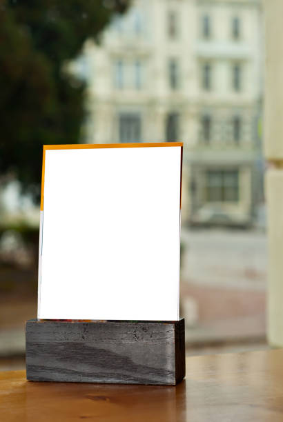 istock Tablet with empty space for text. Blank or layout for design. Mockup for advertising. White plate on a wooden table. 1287065693