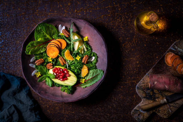 Vegan salad of raw vegetables in moody rusty background Vegan salad of raw vegetables in moody dark rusty background pomegranate in spanish stock pictures, royalty-free photos & images