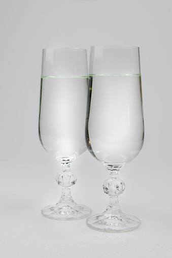 picture of two glasses with champagne on a white background