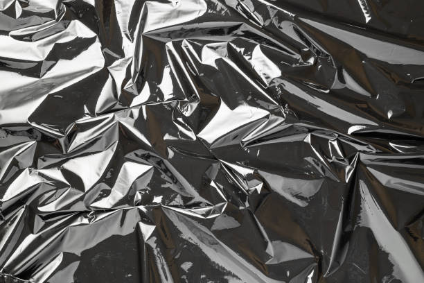 istock Smooth texture. Black shiny film bag pattern. Wrap transparent dark cellophane background. Real texture of polyethylene foil. 1287071824