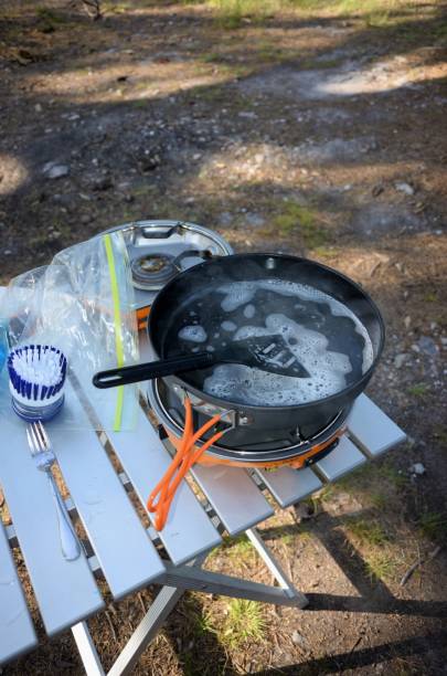 istock Cleaning cooking utensils in camping stove pan 1287071886