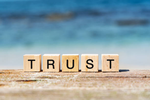 Trust text on wooden block Trust text on wooden block at the beach trust stock pictures, royalty-free photos & images