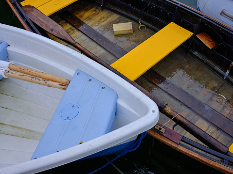 Wooden boats with swedish flags in the harbor of Valdemarsvik on the Baltic Sea coast of Sweden.