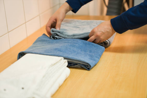 istock A man folds laundry in the laundry room 1287075375