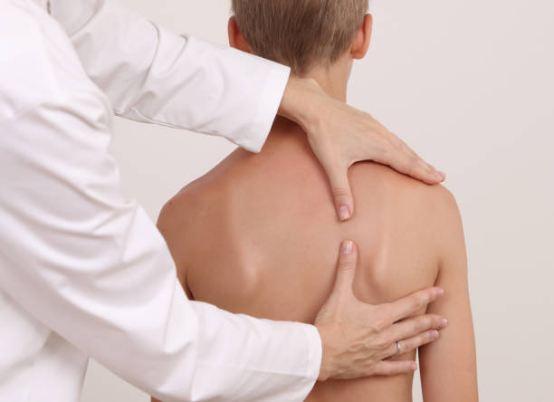 istock Physiotherapist exam for teenage boy. Manual Muscles Tests and Posture Checking . Preventive Health Care Visits in Children 1287077048