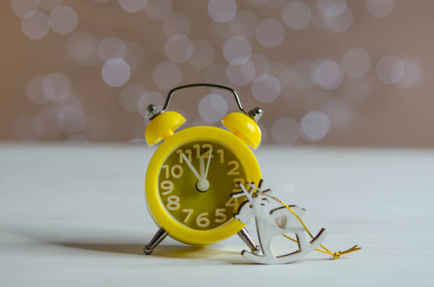 istock Yellow alarm clock on the table. Bokeh. 1287078063