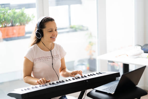 istock Woman Playing Music Keyboard Piano 1287079507