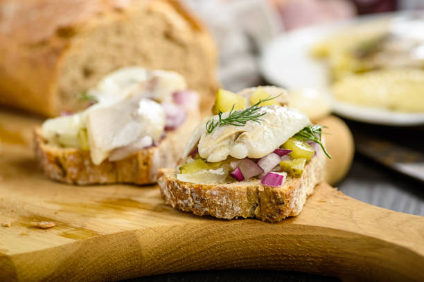 tasty appetizer - sandwiches with herring, onion and cucumber