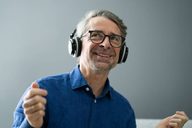 istock Smiling Older Senior Listening Music 1287081161