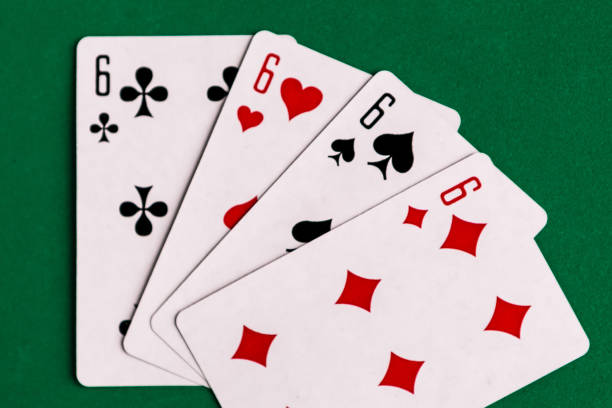 istock Poker quads playing card, green background 1287081308