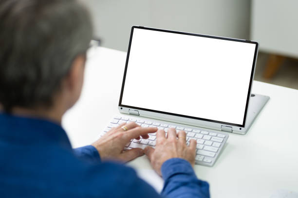 istock Man With Blank Laptop Screen At Desk 1287081691
