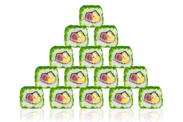 Sushi with tuna, cheese and cucumber in the form of a pyramid. On a white background with reflection.