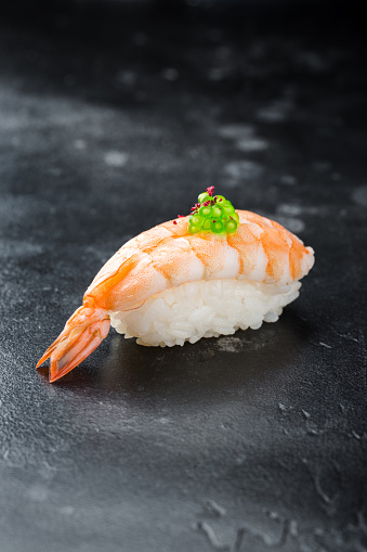 Sushi nigiri with shrimp on black background