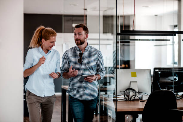 istock Business colleagues walking through the office 1287084854