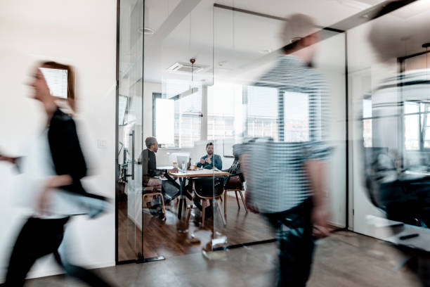 istock Business colleagues walking through the office 1287084874