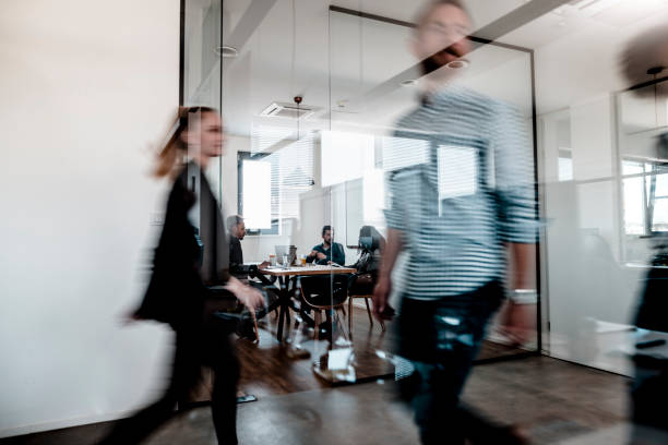 istock Business colleagues walking through the office 1287084886