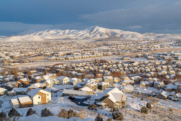 istock Homes in Utah Valley community overlooking mountain against cloudy sky 1287085409