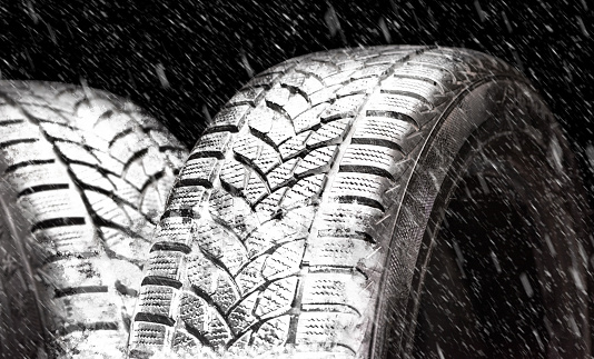 Winter tires in snowfall. High quality and high resolution studio shooting.