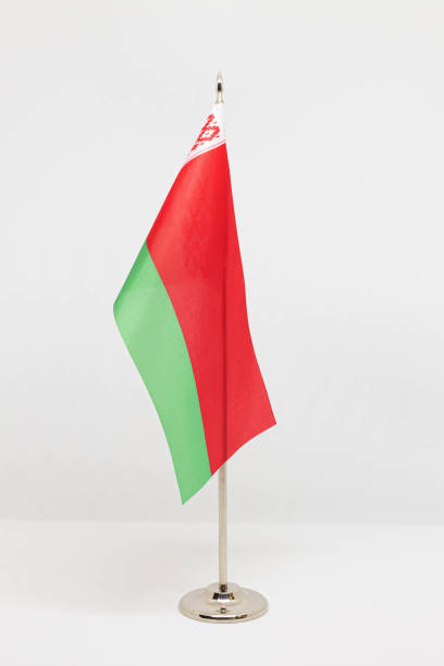istock State desktop flag of Belarus on metal flagpole isolated on white background. 1287086366