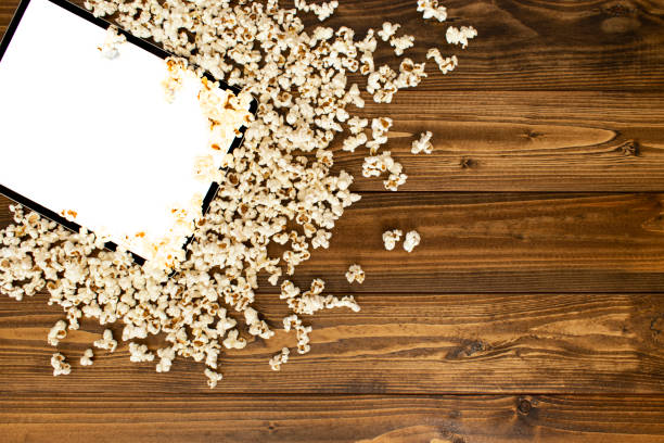 istock Modern tablet computer on the wooden floor. Top view. Tablet mockup with white screen. It is a tablet surrounded by corn and distributed.  Tablet mockup with white copy space. 1287086372