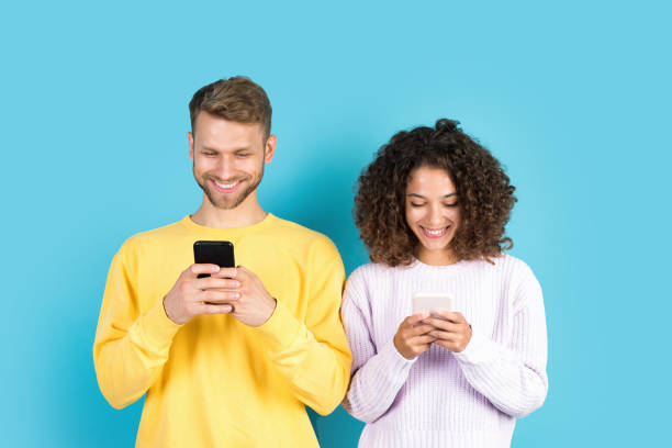 istock Mixed race friends standing on blue background 1287086577