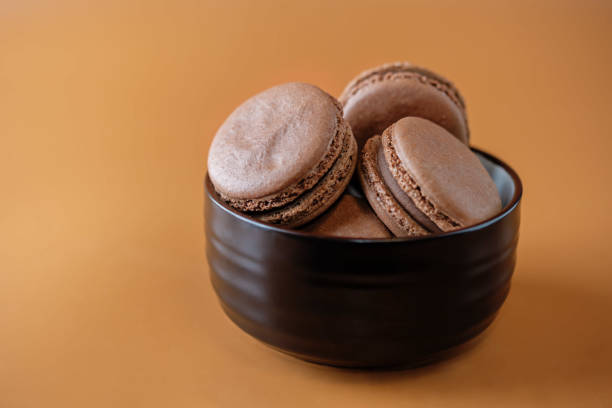 istock Chocolate macarons with chocolate ganache filling 1287089296