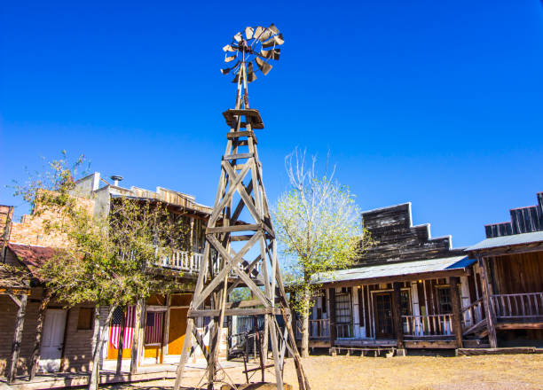 istock Weathered Windmill & Buildings With Draped American Flags 1287089429
