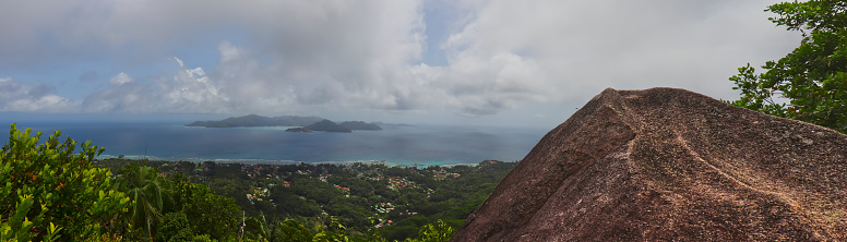 Panoramic view of granite rock and the ocean with the island of praslin. Viewpoint (Nid d'Aigle) in the seychelles.