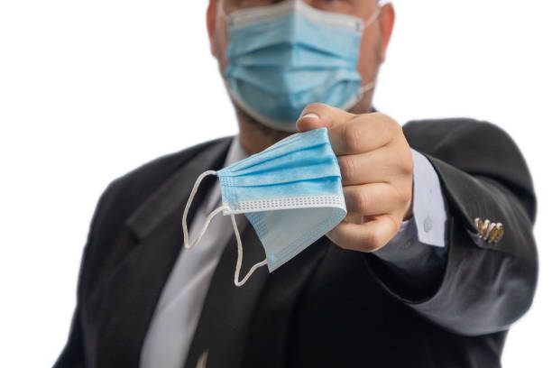istock A man gives a medical mask. 1287091855