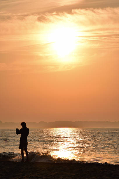 istock Sunset with a strong orange by the sea 1287094871