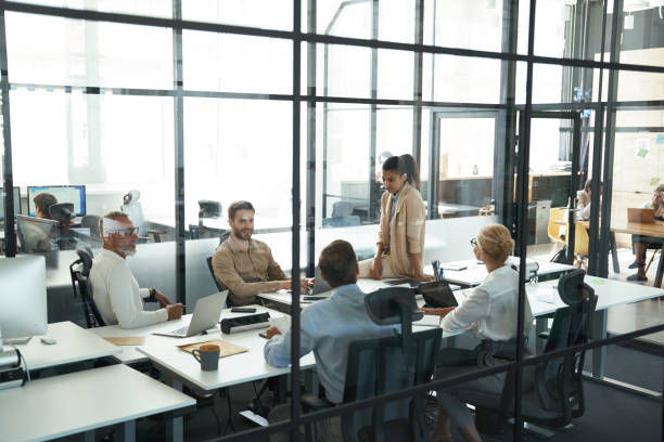 istock Successful multiracial project team sitting in conference room and discussing business while working together in the modern office or coworking space 1287095646
