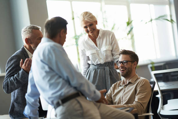 istock Group of multiracial business people talking and smiling, discussing something while working together in the modern office 1287096325