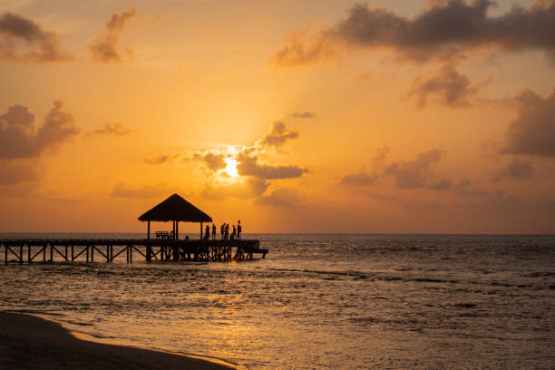 istock End of Pier, Sunset Party, Maldives 1287099046