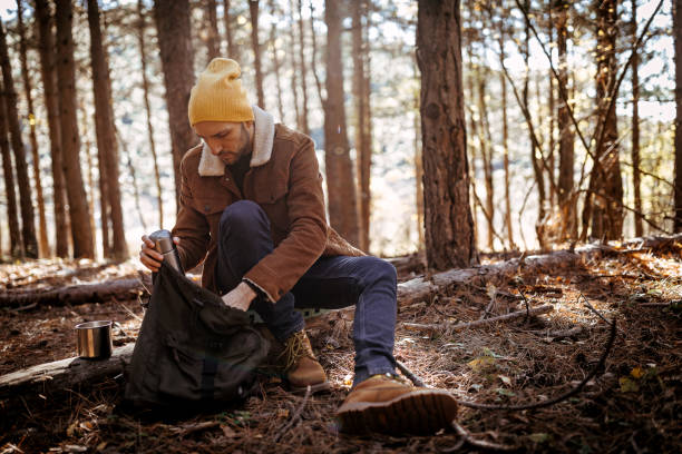 istock Young man enjoying beautiful autumn day in forest 1287100430