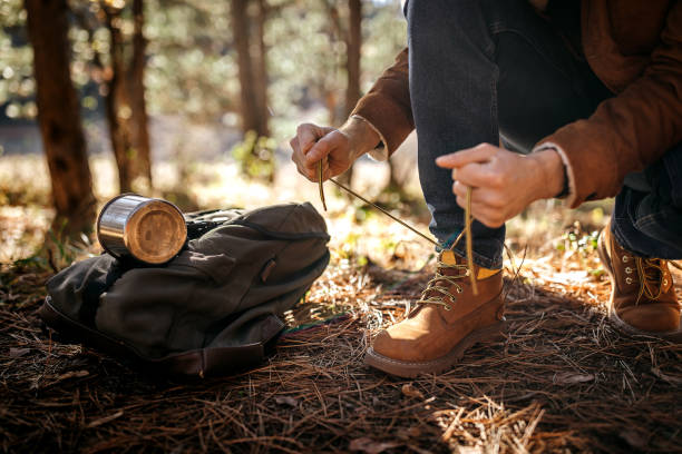 istock Man tying shoelace on boot in woodland 1287100651