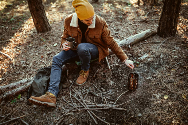 istock Young man enjoying beautiful autumn day in forest 1287100663
