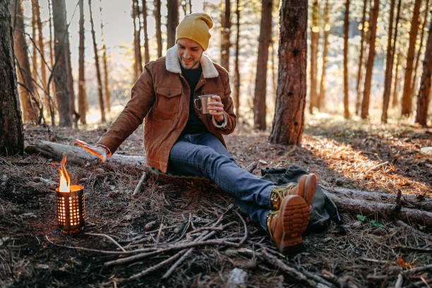 istock Young man spending beautiful autumn day in forest alone 1287100698
