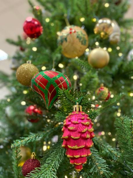 istock Seasons Greetings - Christmas decorations adorn a tree with soft background focus 1287101224