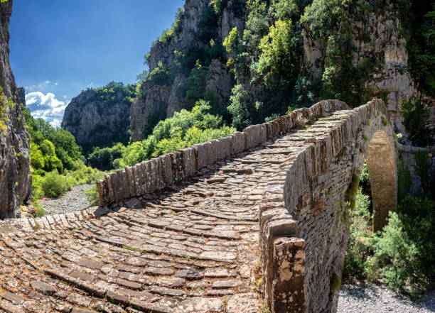Vikos Gorge/ Greece July 25, 2019: The Noutsou bridge (or Kokkori, as it is also known), a single arch stone bridge, is located in central Zagori, between the villages of Koukouli, Dilofo and Kipoi
