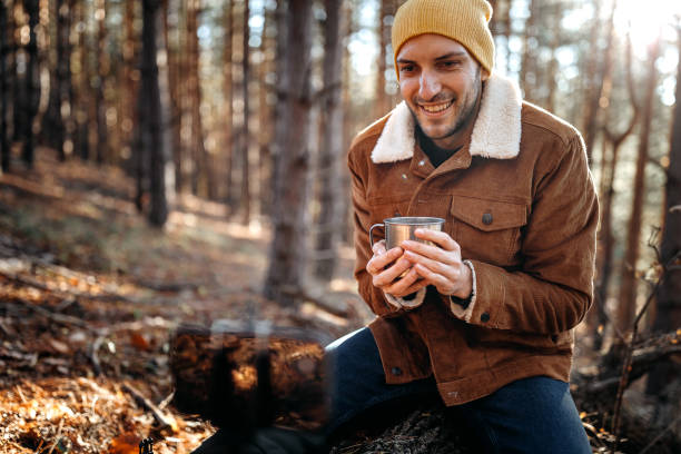 istock Young man recording video for vlog about environmental conservation while enjoying beautiful day in forest 1287101334