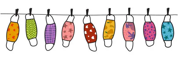 Vector illustration of The colorful masks with fanny pattern are hanging on a line. Reusable, Washable masks.