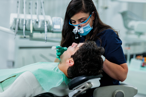 A dentist performing a dental procedure on a patient