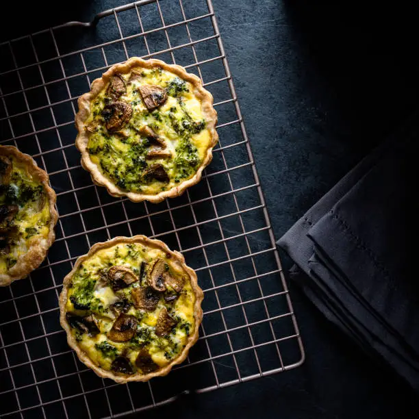 Vegetarian mini-quiches with broccoli, mushrooms, and parmesan cheese.